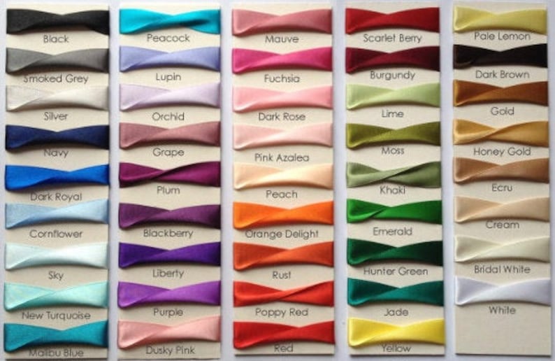 May include: A chart of 36 different colors of satin ribbon, each color is labeled with its name. The colors include black, peacock, mauve, scarlet berry, pale lemon, smoked grey, lupin, fuchsia, burgundy, dark brown, silver, orchid, dark rose, lime, gold, navy, grape, pink azalea, plum, dark royal, peach, khaki, ecru, cornflower, blackberry, orange delight, emerald, sky, liberty, rust, hunter green, bridal white, new turquoise, purple, poppy red, jade, white, malibu blue, dusky pink, red, and yellow.