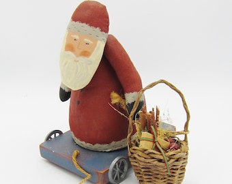 Canvas Santa - Handmade Canvas Santa-Vintage Santa-Unique Folk Art Santa made out of Canvas-Sitting on a Blue Cart with Wheels-Straw Basket.