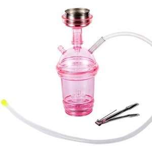 May include: A pink hookah with a clear plastic body and a silver metal top. It has a long, flexible white hose and a pair of silver tongs. The hookah is designed to resemble a beverage cup.