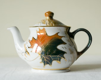 Hand painted autumn-themed porcelain tea pot with orange and green maple leaf. Extravagant teapot with gold accents for elegant tea lover.