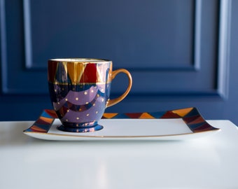 Hand painted porcelain tea cup with dessert/bread plate. Midnight blue geometrically designed dish set with triangles and gold spots.