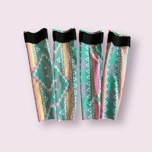 May include: Four colorful leg warmers with a geometric pattern in shades of green, pink, orange, and yellow. Each warmer has a black elastic band at the top.