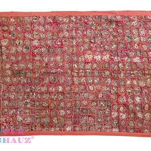 May include: A red and white patchwork quilt with a variety of embroidered designs. The quilt is made up of small squares, each with a different design. The designs include flowers, animals, and geometric patterns. The quilt is edged with a red border.