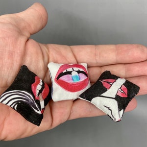 Trio of miniature pillows based on designs of Jonathan Adler