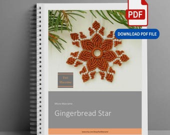 May include: A spiral-bound instructional guide titled Gingerbread Star by Ewi Macrame. The cover features a brown and white macrame star ornament, green pine needles, and a PDF download icon. The text includes Micro Macrame and the website URL.