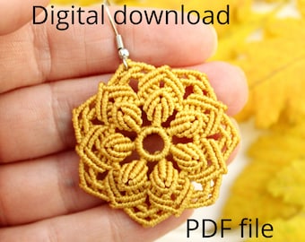 May include: A close-up of a yellow crocheted flower earring with a silver hook. The earring is held in a hand against a background of yellow leaves. The text "Digital download PDF file" is visible in the image.