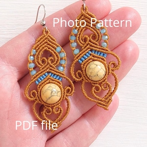 May include: Handmade macrame earrings with a unique design. The earrings feature a tan-colored woven pattern, accented with light blue beads and a central cream-colored stone. The text "Photo Pattern" and "PDF file" are visible.