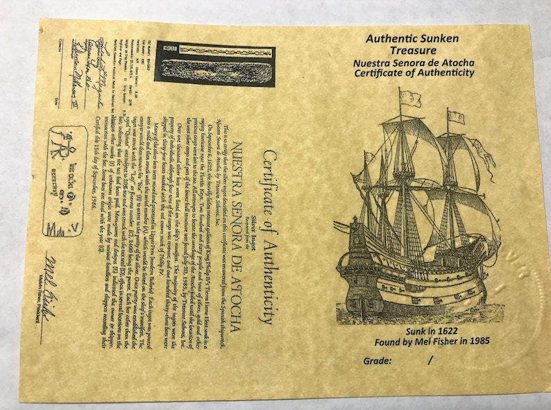 May include: A certificate of authenticity for a silver ingot recovered from the Nuestra Senora de Atocha shipwreck. The certificate features a detailed illustration of the ship, with the text "Sunk in 1622 Found by Mel Fisher in 1985".