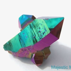 May include: A cluster of iridescent rainbow titanium quartz crystals with a green, purple, and blue color scheme. The crystals are sharp and have a metallic sheen.