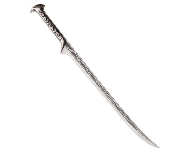May include: A silver sword with a detailed, intricate design on the blade and handle. The sword has a pointed tip and a curved handle.