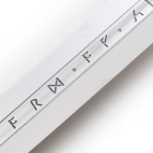 May include: Close-up of a silver blade with the inscription "F.R.M. F. F. H" etched into the surface.