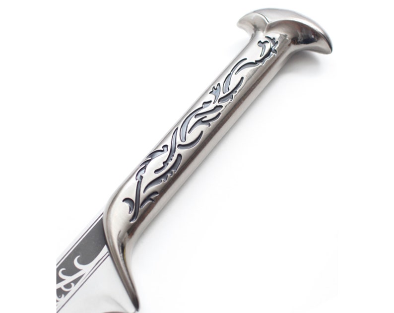 May include: A silver sword with a black and silver handle. The handle has an intricate design of swirling vines.