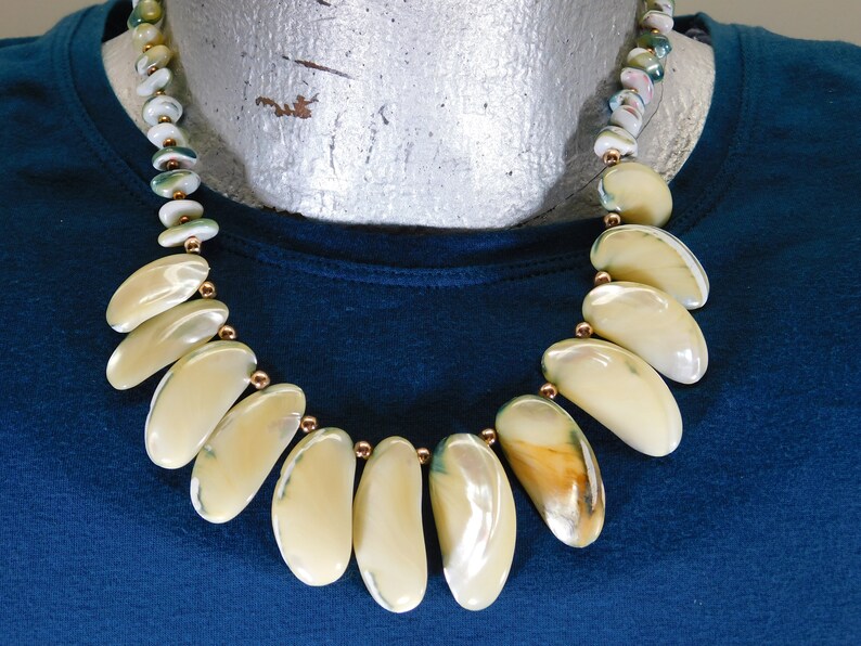 Shell necklace with blue green edges gold spacer beads and barrel clasp
