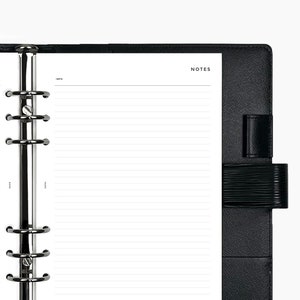 May include: A black leather bound notebook with a silver ring binder and lined pages. The cover has the word "NOTES" printed in white.