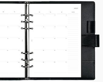 May include: A black leather binder with a six-ring metal mechanism holding a white 2027 monthly calendar insert. The planner features a textured cover, a side pen loop, and a grid layout with dedicated space for notes on the right side of the page.