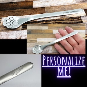 May include: Three silver spoons with paw print designs. The spoons are engraved with personalized messages: "Patches Grandpaw", "With love", and "Good Morning!"