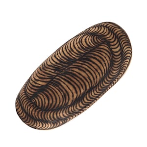 May include: A wooden bowl with a black and brown wavy pattern. The bowl is oval shaped and has a smooth, polished surface.