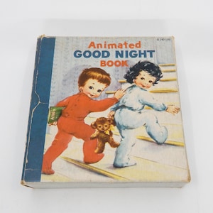 May include: Vintage children's book titled "Animated Good Night Book." The cover shows illustrations of two children in pyjamas, one in red and the other in blue, walking up stairs. A teddy bear is also featured.