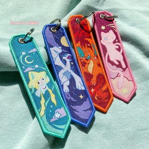 Jirachi, Lugia, Charizard, Mew Jet Tag Keychain (1.25 x 5 inch)