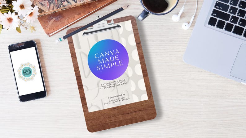 May include: A wooden clipboard with the text "CANVA MADE SIMPLE" is the focal point of this image. A smartphone, laptop, coffee cup, and headphones are also visible. The image has a clean, organized aesthetic, suggesting a workspace or study environment.