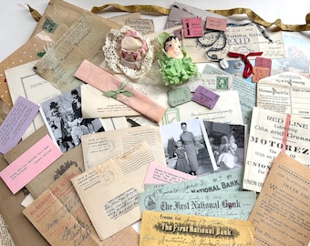 May include: A collection of vintage ephemera, including old photographs, postcards, receipts, and bank notes. The items are arranged on a light background, with a small doll and a ribbon adding color. The items are in various sizes and shapes.