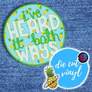 May include: A round, blue and green sticker with a pineapple pattern. The sticker says "I've heard it both ways" in white text. The sticker is labelled "die cut vinyl" in blue text.
