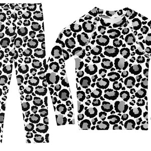 May include: A black and white leopard print long-sleeved shirt and matching leggings set.
