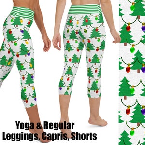 May include: White yoga leggings and capris with a repeating pattern of green Christmas trees and colorful string lights. The waistband is green and white striped. The text "Yoga & Regular Leggings, Capris, Shorts" is at the bottom.