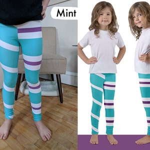 May include: Mint coloured leggings with white and purple stripes. The leggings have a swirl pattern. The word "Mint" is written in white text on a purple background.