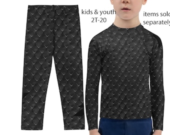 May include: Black long-sleeved shirt and leggings with a scale pattern. The shirt has a crew neck and the leggings are full length. The text "kids & youth 2T-20" and "items sold separately" is printed on the image.