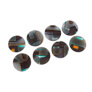 May include: Eight round, gray and black plastic bases with a teal and orange design. The bases are for miniature figures.