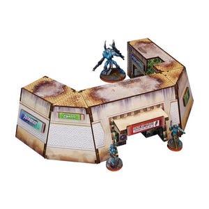 May include: A beige and brown cardboard model of a futuristic building with a large doorway and a sign that reads "DOCK 411 FIRE EXIT". The building has several windows and a white, textured surface. There are several small, blue and green figures standing in front of the building.