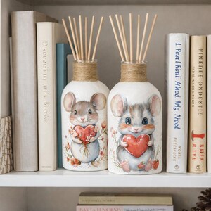 May include: A set of three ceramic mugs with a speckled, matte finish. Each mug is a different colour: light blue, cream, and grey. The mugs have a simple, modern design and a comfortable handle.