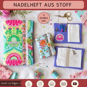 May include: A PDF sewing pattern for fabric needle books by Sami Dolls. The image displays two finished needle books in different sizes, featuring colorful floral patterns, lace trim, and button closures, alongside sewing tools like scissors and pins.