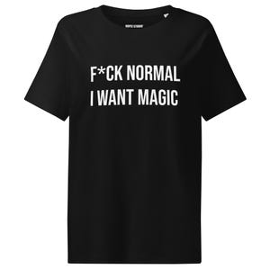 Puede incluir: Camiseta negra con el texto blanco "F*CK NORMAL I WANT MAGIC". La camiseta tiene mangas cortas y cuello redondo. El nombre de la marca "OOPSI STUDIO" está impreso en la parte superior.
