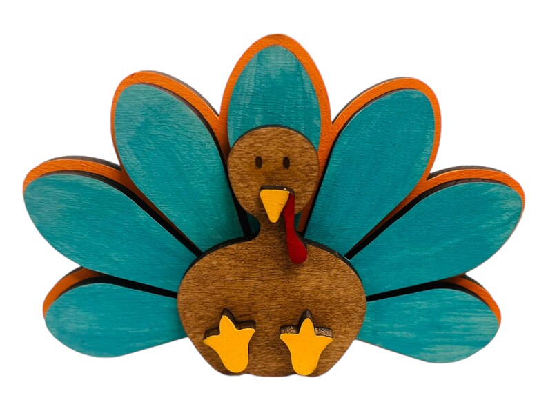 May include: A wooden turkey figurine with a brown body, red wattle, and yellow feet. The turkey has a teal blue tail with orange accents.