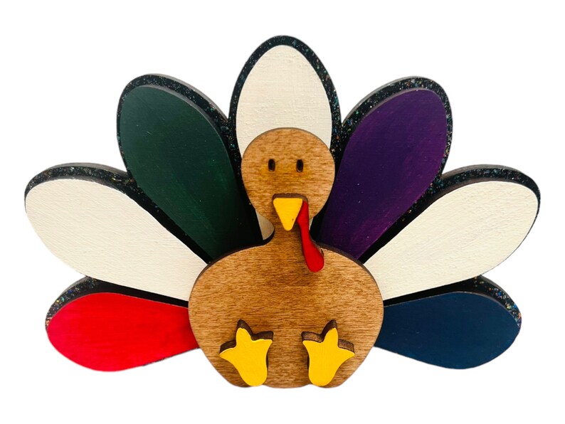 May include: A wooden turkey figurine with a brown body, red wattle, yellow feet, and a colorful tail with white, green, purple, red, and blue feathers.