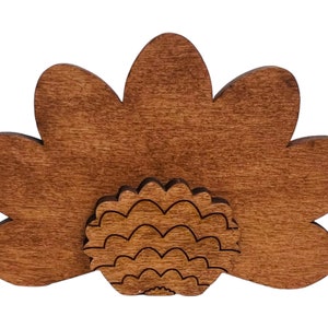 May include: A wooden turkey cutout with a brown stain. The turkey has a fan-shaped tail and a detailed body.