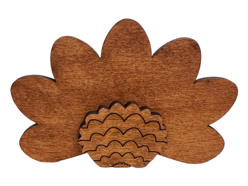May include: A wooden turkey cutout with a brown stain. The turkey has a fan-shaped tail and a detailed body.