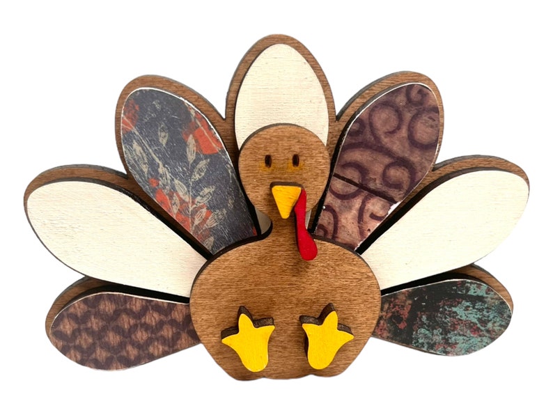 May include: A wooden turkey figurine with a brown body, red wattle, yellow feet, and a patterned tail with white, brown, and blue accents.