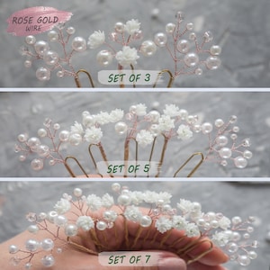 May include: Set of three, five, and seven hair combs with white flowers and pearl beads on rose gold wire. The combs are arranged in rows, with the set of three at the top, the set of five in the middle, and the set of seven at the bottom. The text "SET OF 3", "SET OF 5", and "SET OF 7" is printed below each row of combs.