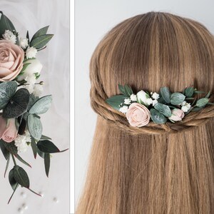 May include: A floral hair comb featuring a large, light pink rose, smaller pink buds, white flowers, and green leaves. The comb is designed with a mix of textures and colors, perfect for bridal or special occasion hairstyles.