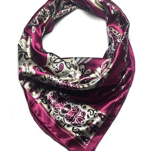May include: A burgundy satin scarf with a paisley pattern in shades of cream, brown, and black.