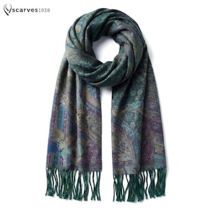 May include: A scarf featuring a dark green, purple, and blue paisley pattern with intricate floral details and fringe at both ends. The text "scarves1938" is visible in the top left corner. The fabric displays a woven texture throughout.