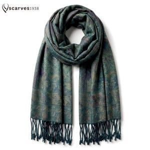 May include: A teal scarf featuring a dark green and purple paisley pattern with intricate floral motifs. The scarf has a looped top section and long, thin fringe tassels along the bottom edges. The text "scarves1938" appears in the top left corner.
