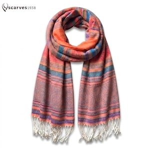 May include: A rectangular scarf featuring a vibrant pattern of horizontal stripes in shades of orange, blue, and purple. The fabric displays intricate woven textures and geometric details throughout. The ends are finished with white fringe tassels.