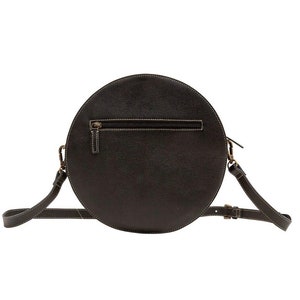 May include: A black round leather crossbody bag with a top zipper closure and an adjustable strap.