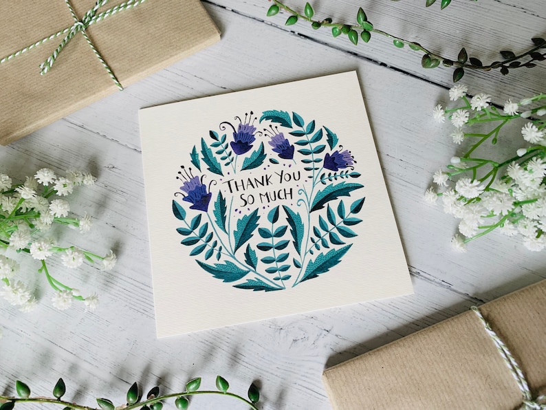 May include: A white card with a blue and green floral design and the text "Thank You So Much".