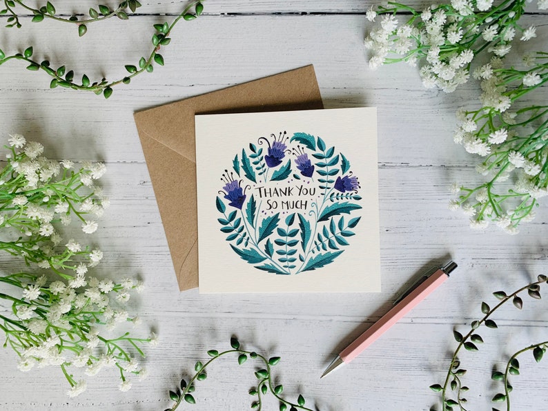 May include: A thank you card with a floral design featuring purple flowers and green leaves. The card says "Thank You So Much".