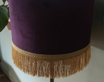 Purple velvet lampshade with gold fringe.